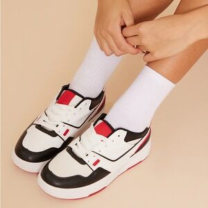 New red, black and white sneakers, size 8. Never worn.